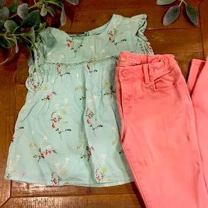 A mint green floral t-shirt with pink jeans.